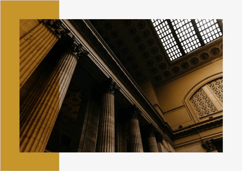 Classical courthouse architecture and stone pillars representing legal authority, heritage, and justice for MI Law firm.