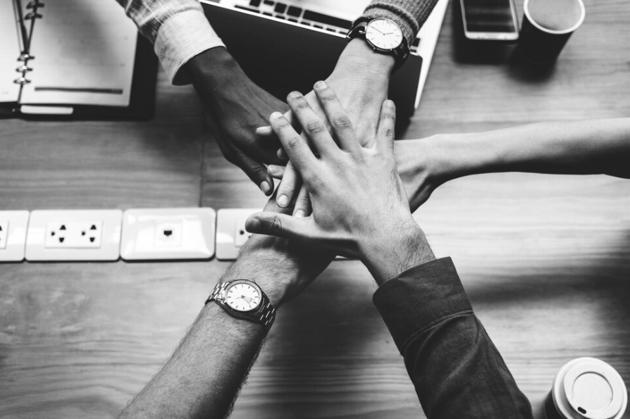 Diverse legal team collaboration and partnership concept representing client advocacy and corporate legal services at Redbridge Solicitors.