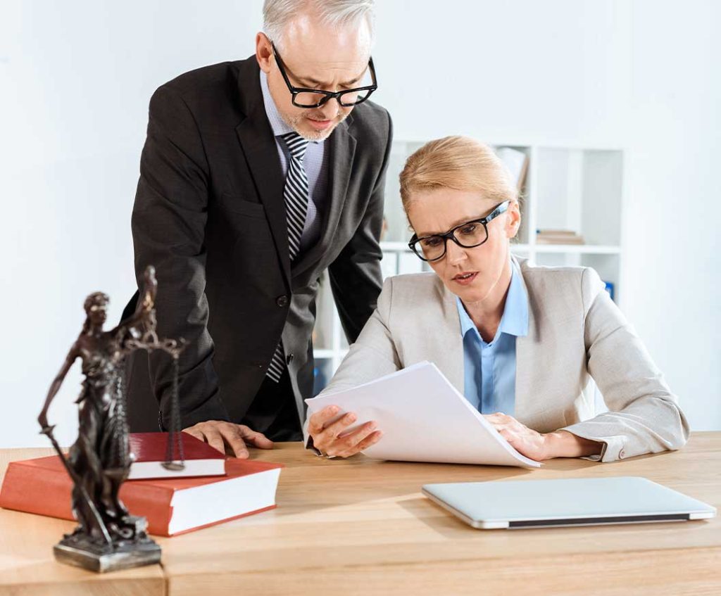 Experienced attorneys conducting joint legal document analysis and corporate law consultation at Redbridge Solicitors.